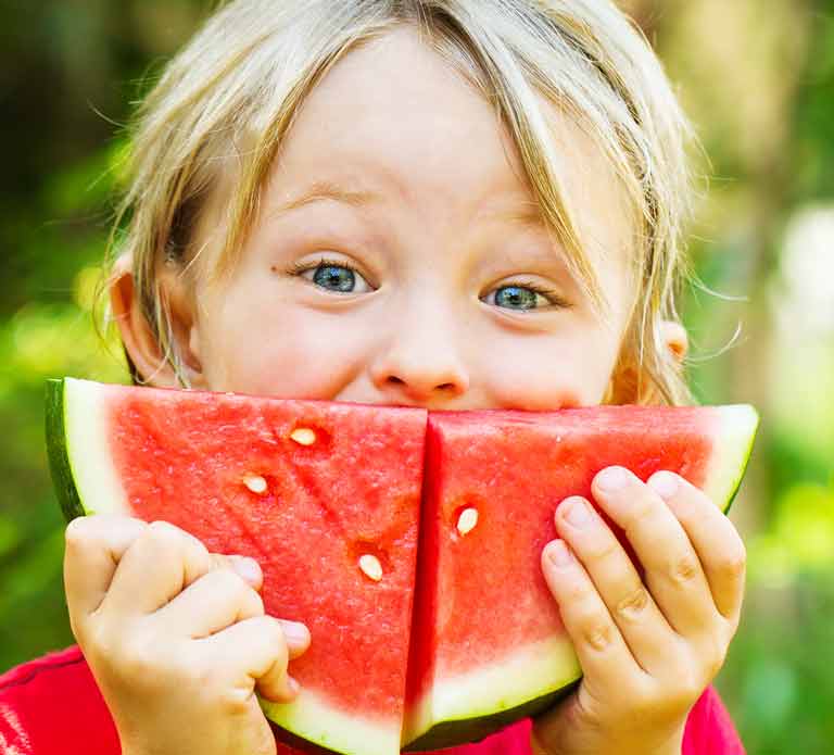 smiling child eating watermelon