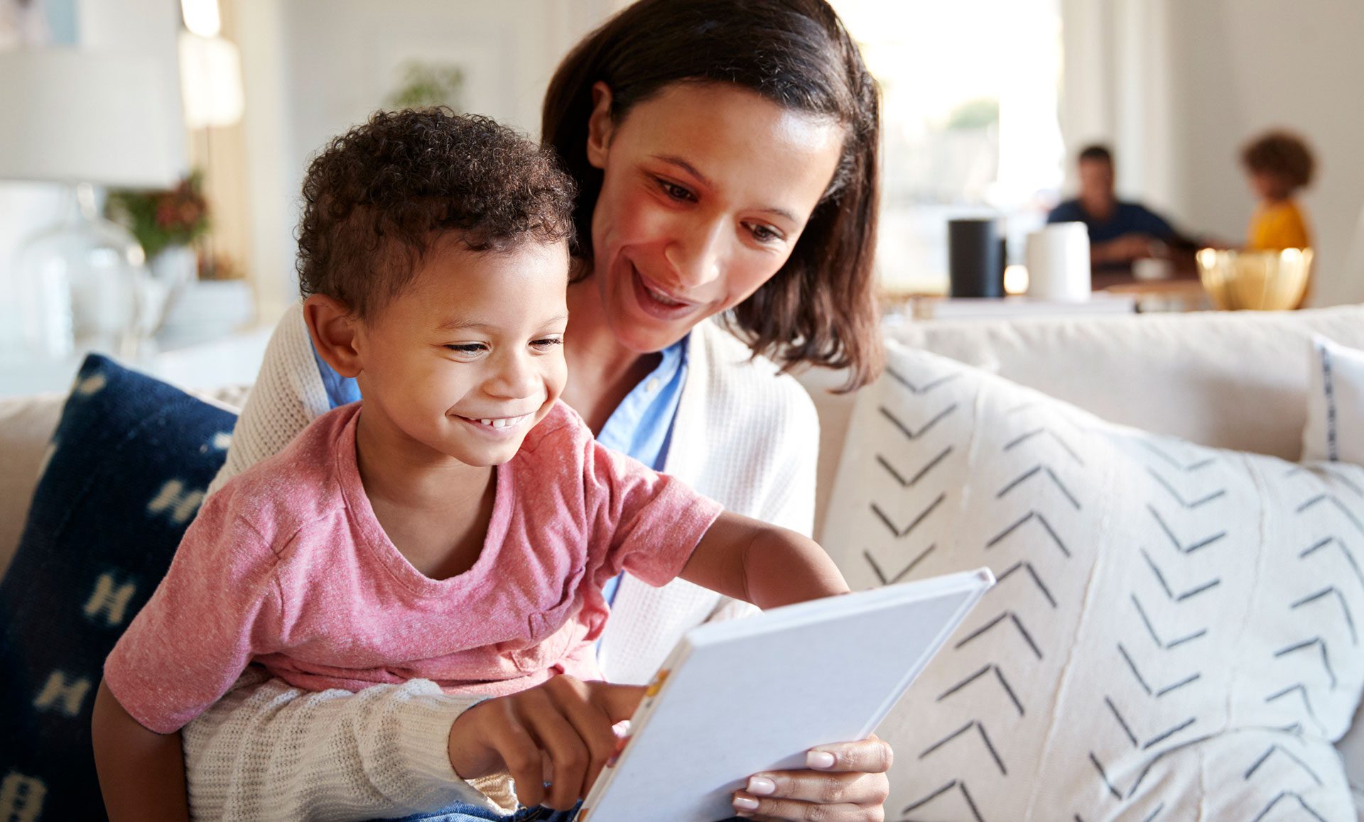 child and adult using a tablet