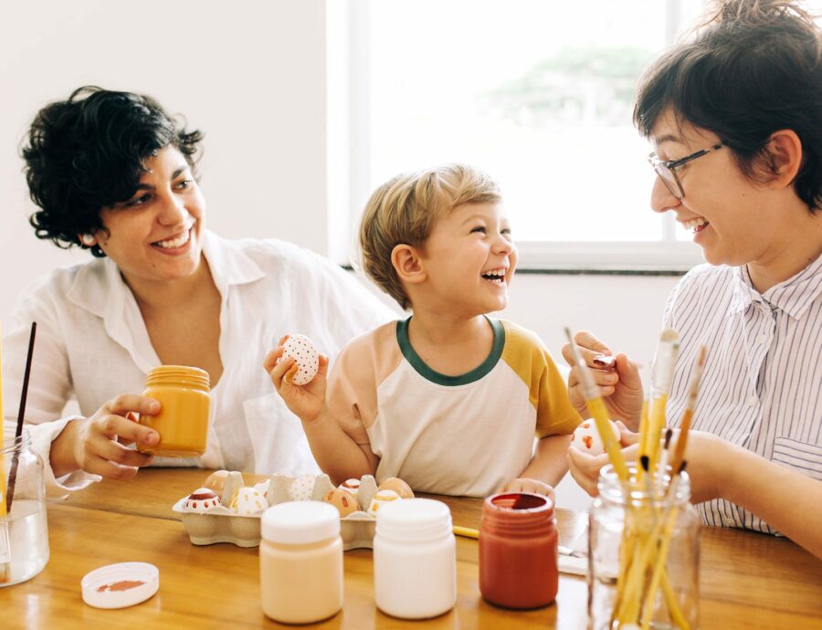 parents and child decorating eggs