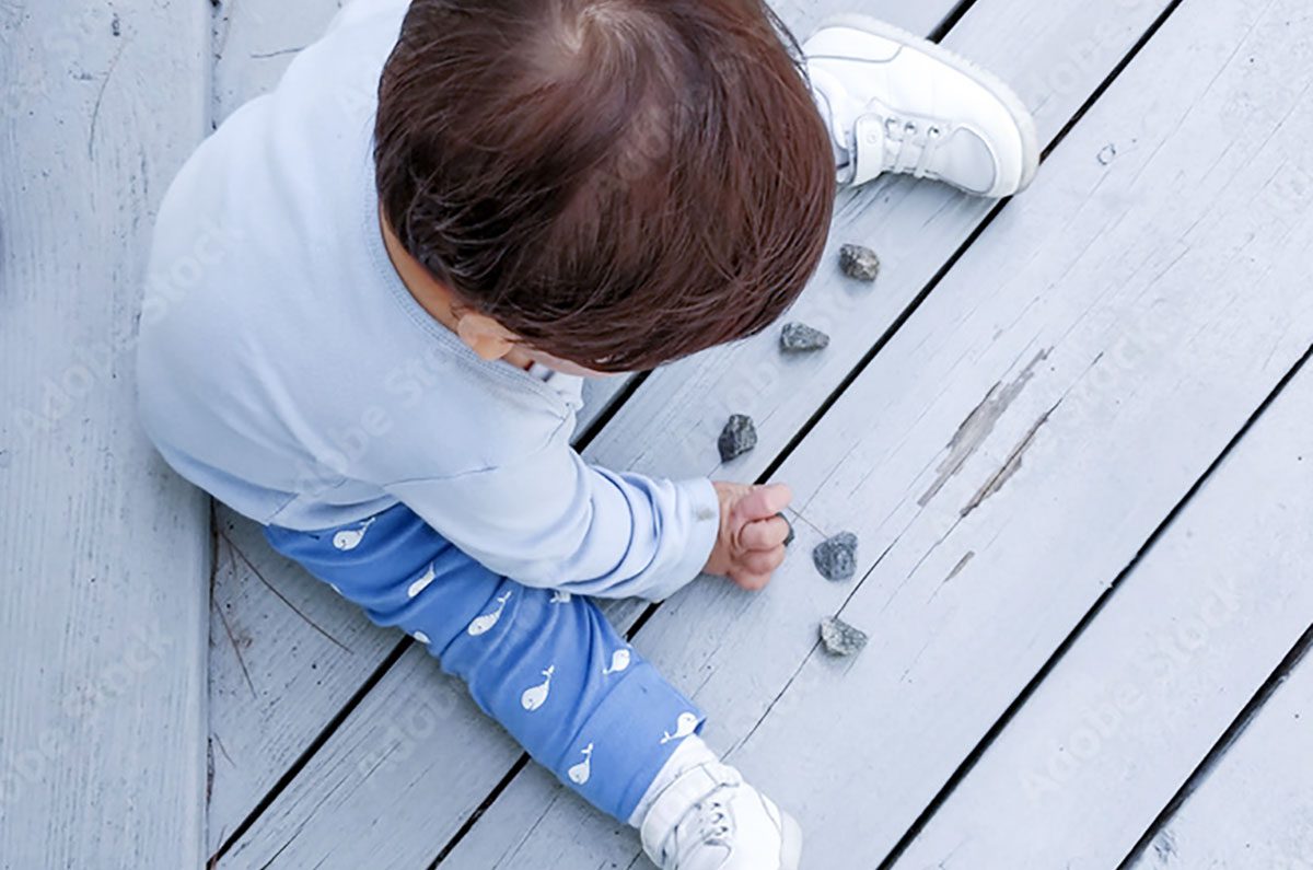 child counting rocks