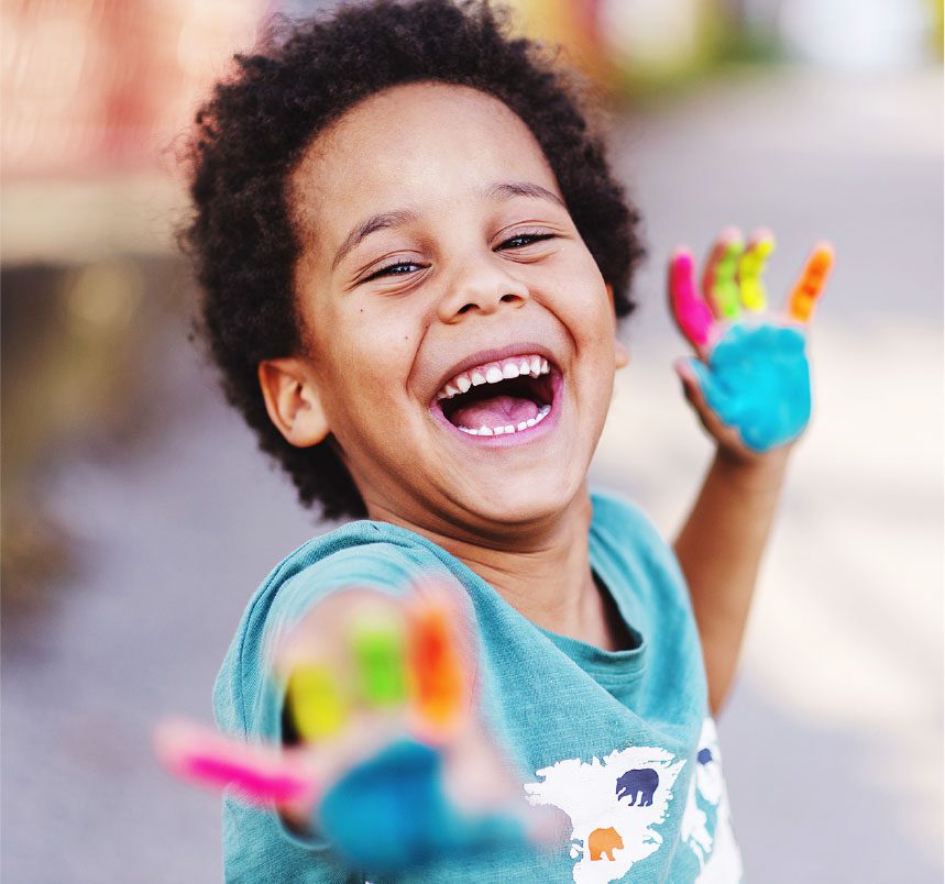 happy child with colorful paint on hands