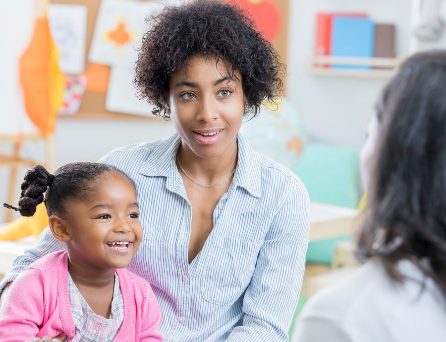 parent and teacher and child discussion inclassroom