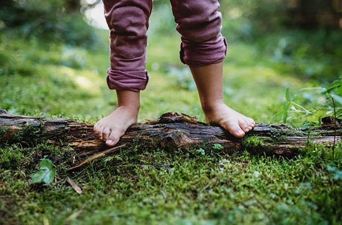 child standing on log